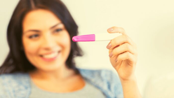 Close up of Happy Woman with Home Pregnancy Test