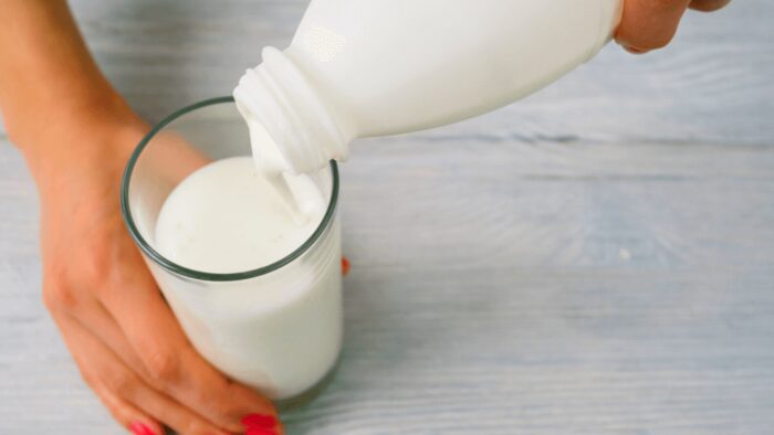 pouring kefir from a bottle