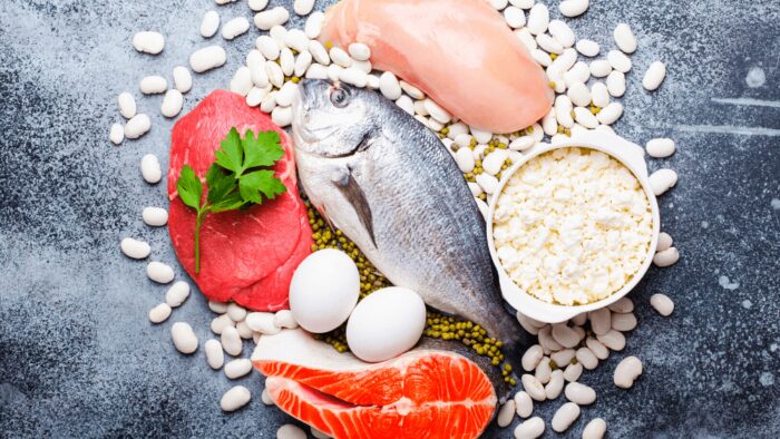 protein foods on a table- fish, beef, chicken, eggs