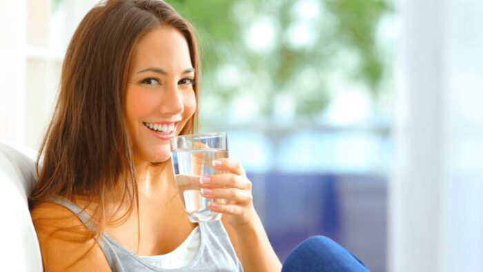 woman drinking a glass of water