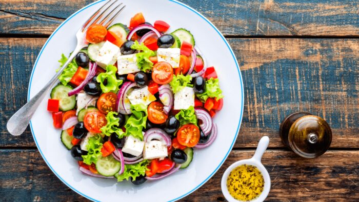 Greek salad of fresh cucumber, tomato, sweet pepper, lettuce, red onion