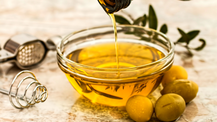 pouring olive oil into a bowl