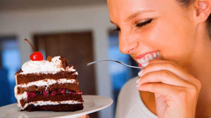 woman enjoying a piece of cake
