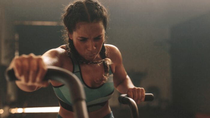 woman doing intense cardio exercise on bike