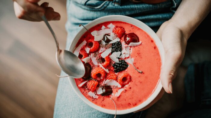 Woman eating healthy smoothie bowl