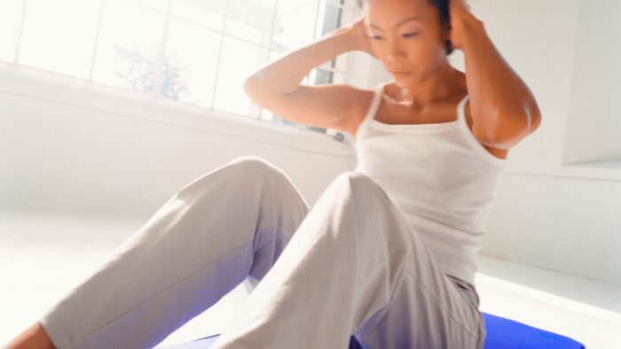 a young woman performing stretching exercises on a exercise