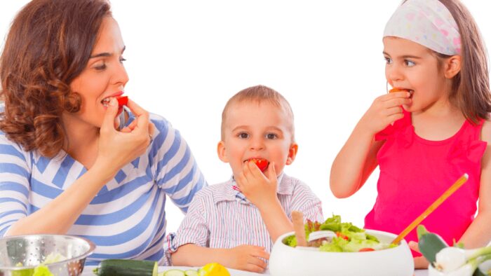 family enjoying eating vegetables