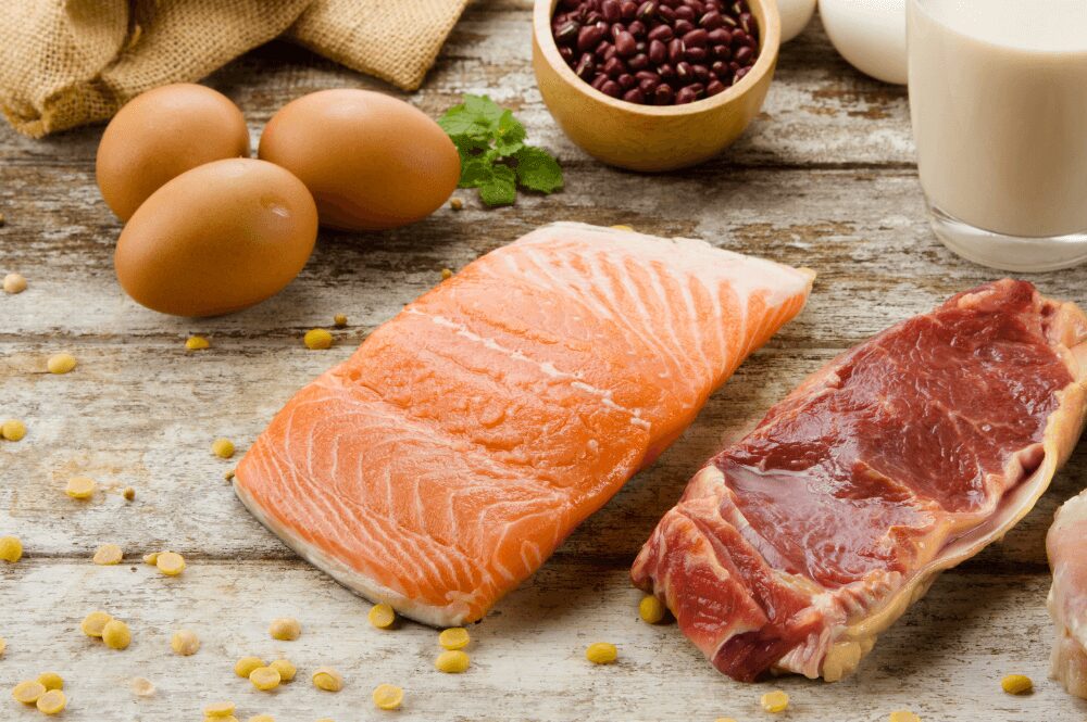 beef steak, salmon, and 3 hardboiled eggs on table