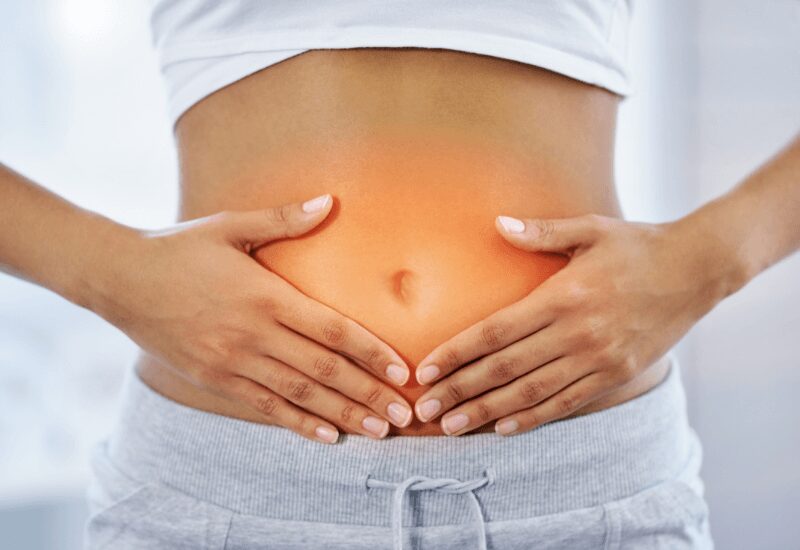 woman touching her belly signaling a happy gut