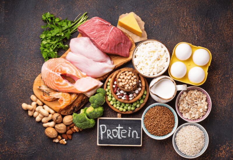 table with foods high in protein- fish, eggs, beef, pork, eggs