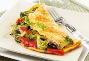 This dish benefits from an easy-to-make omelet filling to give it taste and nutrition. To prepare the filling, cook veggies in a little bit of oil. Then the eggs are added and cooked until firm.