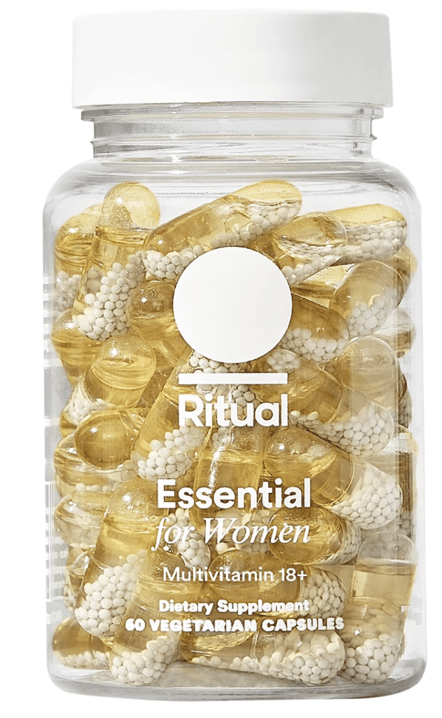 This is an image of Ritual's multivitamin bottle, sleek and cylindrical in shape. It's transparent, showcasing the yellow, bead-like vitamins inside, symbolizing its no-secrets approach to ingredients. The label is minimalist and modern, with 'Ritual' printed in bold, black letters against a clean, white background. The product promises essential nutrients for different life stages, encapsulating health and wellness.