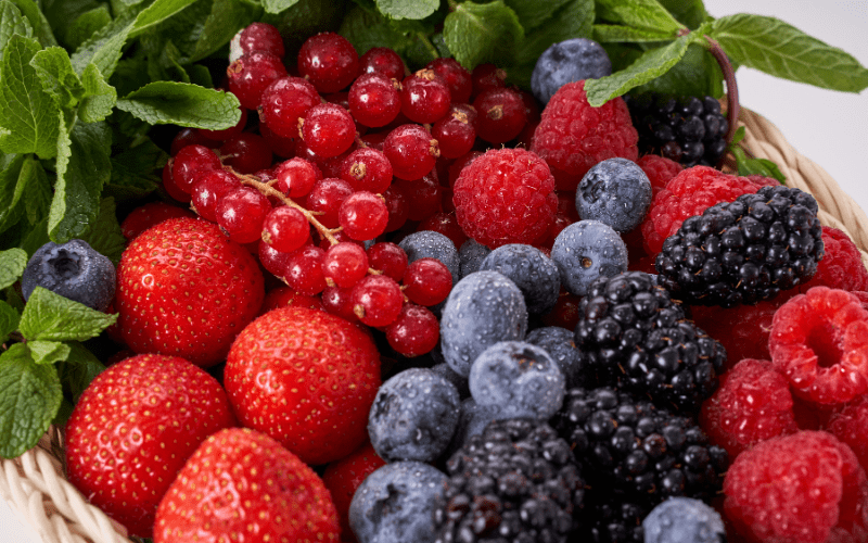 An assortment of fresh, colorful berries including strawberries, blueberries, raspberries, and blackberries. The vibrant mix showcases the natural diversity and rich hues of these delicious and nutritious fruits, enticing the senses with their visual appeal.